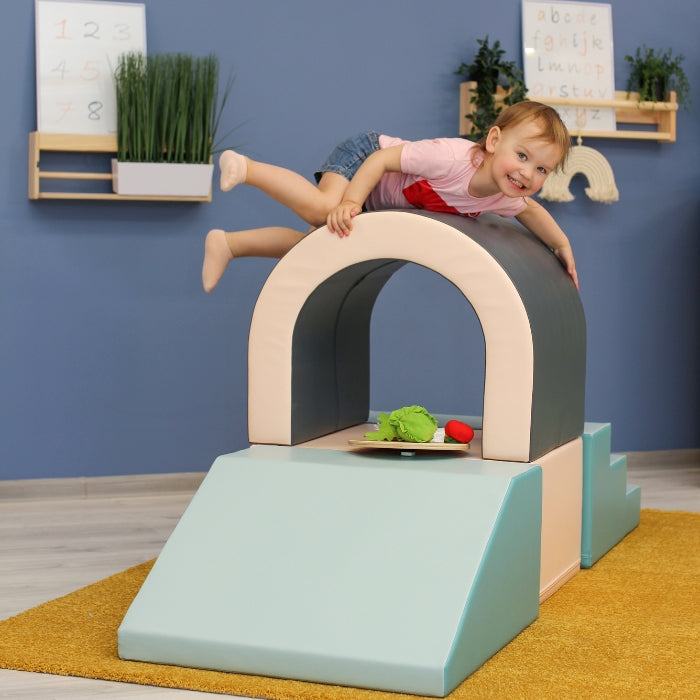 A girl playing on her tunnel soft play set