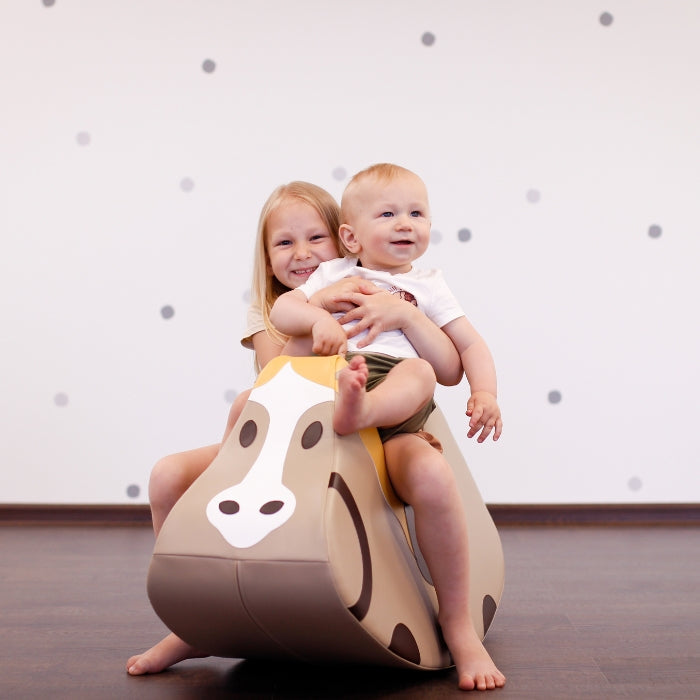 Two children balance on a Soft Play Ride On Toy - Wild Horse by IGLU Soft Play, engaging their imagination and developing gross motor skills.