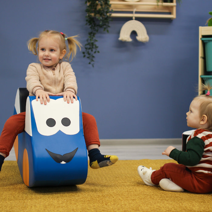 A girl rocking on an IGLU toy rocker