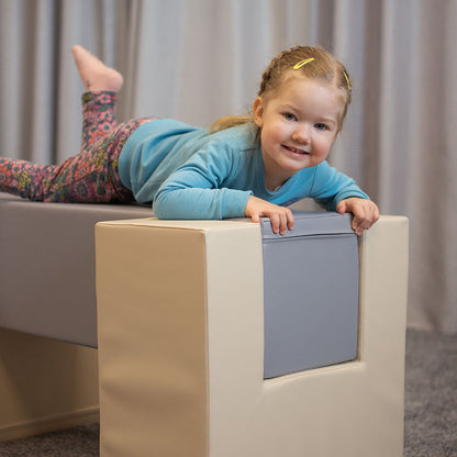 A young girl balancing on top of a box in the IGLU Soft Play - Balance Bridge soft play activity set.