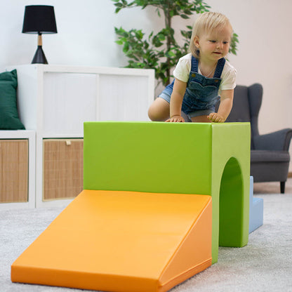 A child is having fun on a green IGLU Soft Play - Mini Tunnel Climber, promoting physical development.