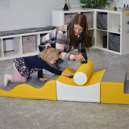 A woman and a child balancing on an IGLU Soft Play - Advanced Wave Walk soft play set.