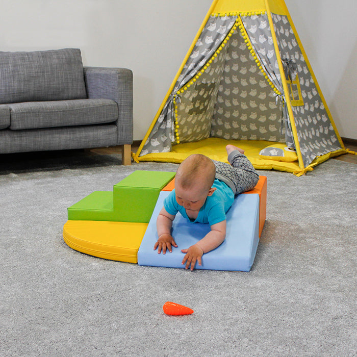 An IGLU Soft Play Corner Crawler is laying on a teepee in a living room.