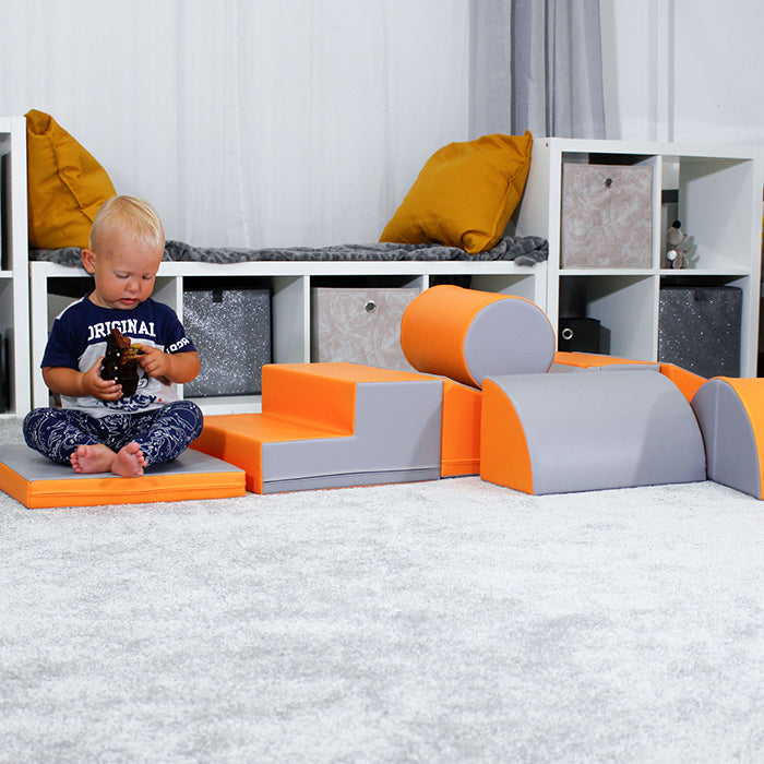 A child is using a Soft Play Activity Set - Adventurer by IGLU Soft Play in a room for physical activity.