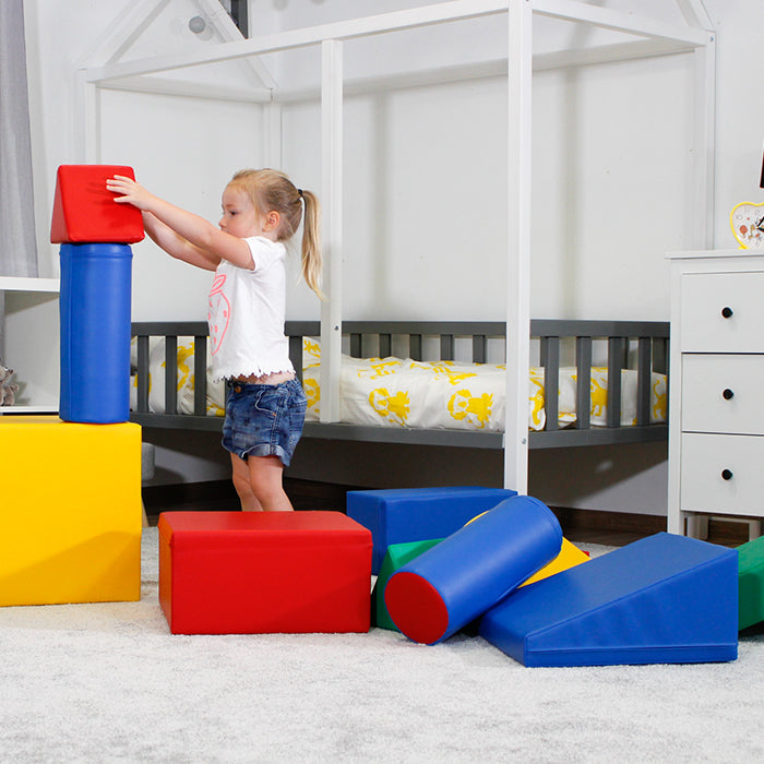 A little girl playing with an IGLU Soft Play - Castle set in a room.