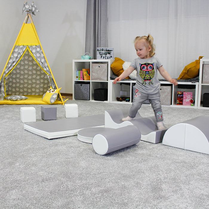 A girl is balancing on an IGLU wave set