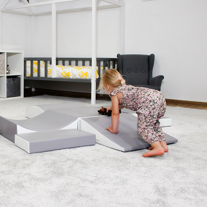 A little girl engaging in interactive play on an IGLU Soft Play - Little Crawler XL, stimulating imagination and supporting physical development.