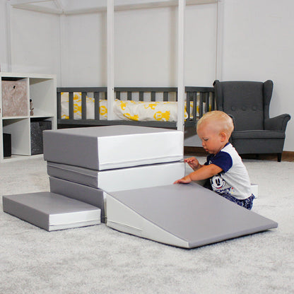 A baby engages in interactive play and stimulates physical development while using their imagination with a Soft Play Set - Little Crawler XL by IGLU Soft Play in a room.