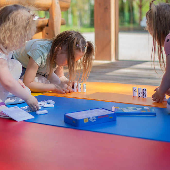 Girls playing dominos on foam mattresses 