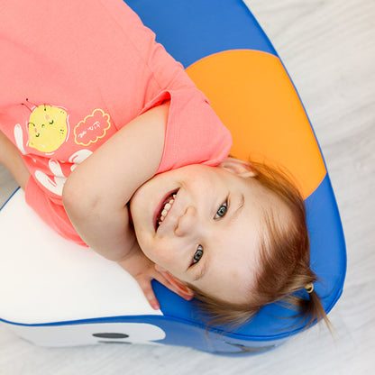 A girl smiling laying on her IGLU car rocker toy