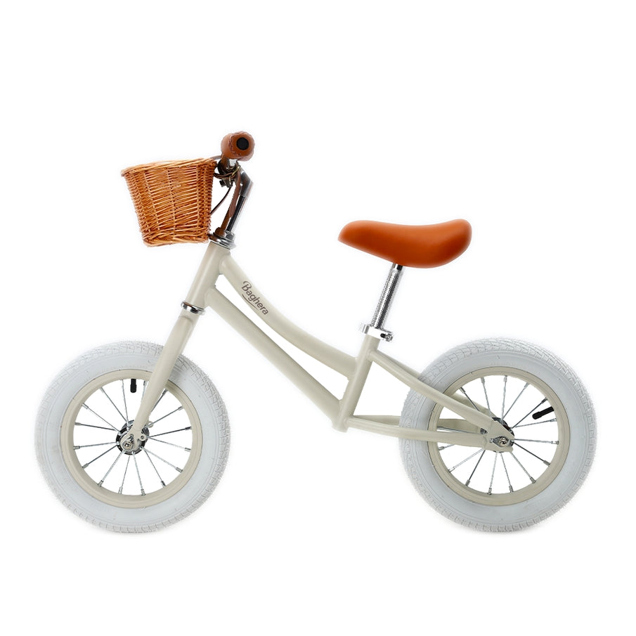 Vintage balance bike beige with wicker basket and crash helmet