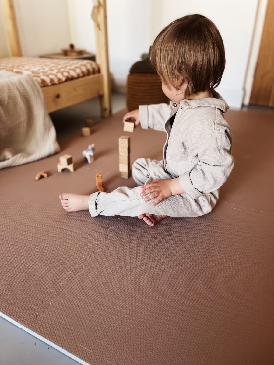 Eeveve speelmat Cinnamon in warme kaneeltint bij een houten vloer